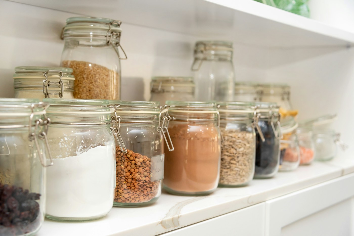 Kitchen shelves arranged with jars and pantry essentials