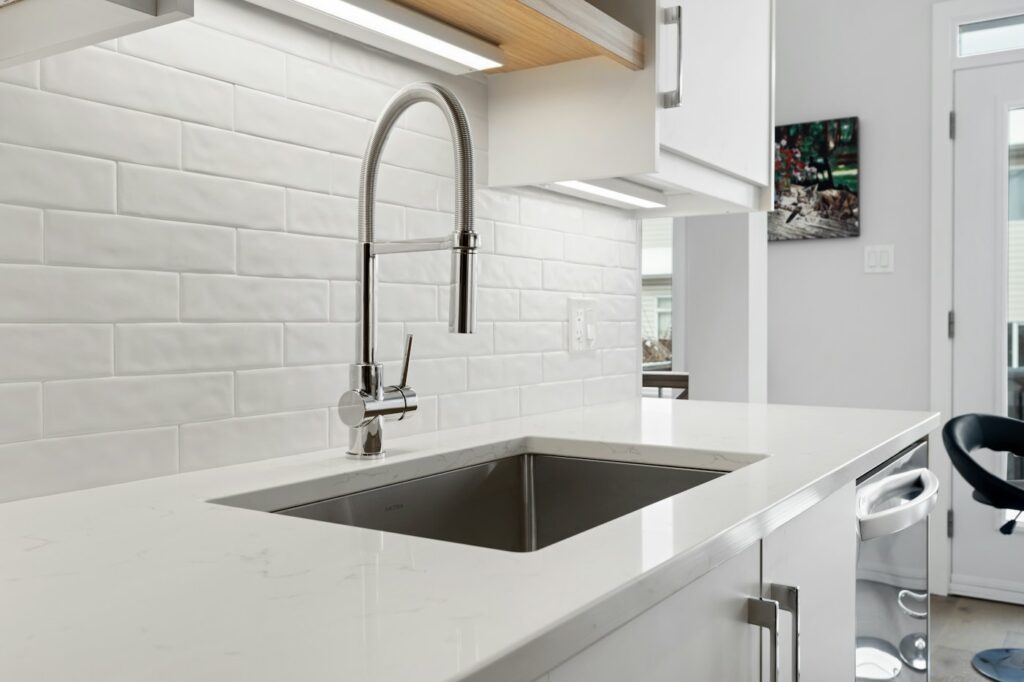 Kitchen sink below a window with cabinets underneath