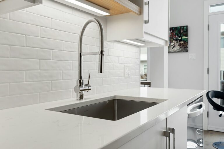 Kitchen sink below a window with cabinets underneath