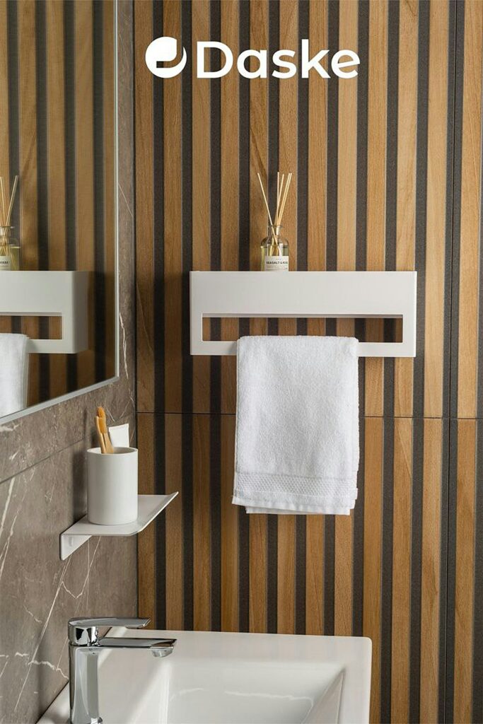 Small bathroom with a sink, toilet, and towel rack